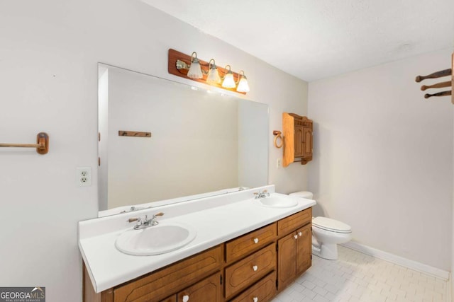 2617 Laurel Woods Ln SE, Conyers, GA 30094 - full bathroom featuring double vanity, toilet, baseboards, and tile patterned flooring