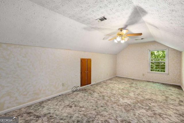 2617 Laurel Woods Ln SE, Conyers, GA 30094 - additional living space with vaulted ceiling, a textured ceiling, carpet, baseboards, and a ceiling fan