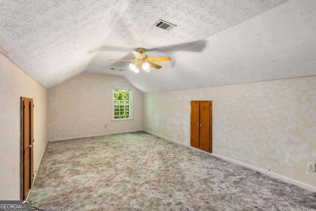 2617 Laurel Woods Ln SE, Conyers, GA 30094 - additional living space featuring a ceiling fan, carpet flooring, vaulted ceiling, a textured ceiling, and baseboards