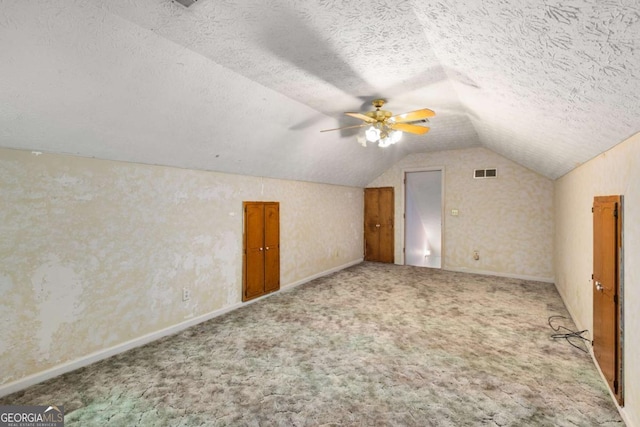 2617 Laurel Woods Ln SE, Conyers, GA 30094 - bonus room featuring vaulted ceiling, carpet, a textured ceiling, baseboards, and ceiling fan
