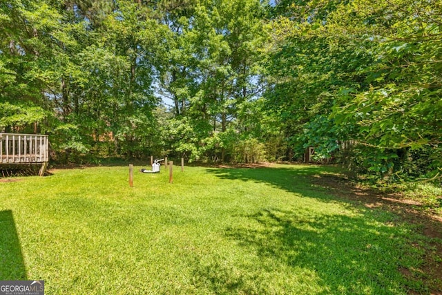 2617 Laurel Woods Ln SE, Conyers, GA 30094 - view of grassy yard featuring a wooden deck