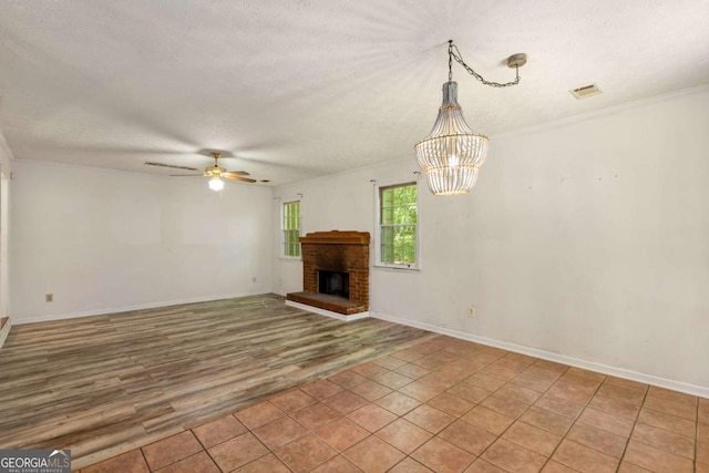 2617 Laurel Woods Ln SE, Conyers, GA 30094 - unfurnished living room featuring ceiling fan, a textured ceiling, light wood-style floors, a chandelier, and a fireplace