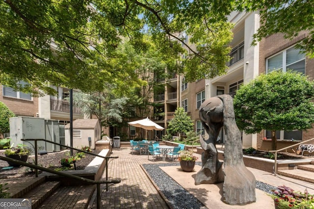 390 17th St NW Unit 2040, Atlanta, GA 30363 - surrounding community with a patio area, outdoor dining space, and a shed