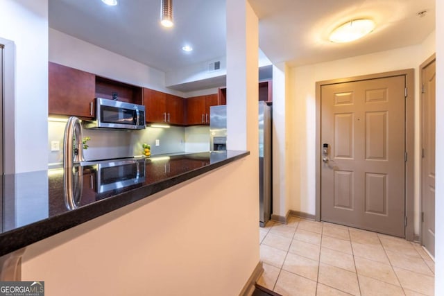 390 17th St NW Unit 2040, Atlanta, GA 30363 - kitchen featuring appliances with stainless steel finishes and light tile patterned flooring