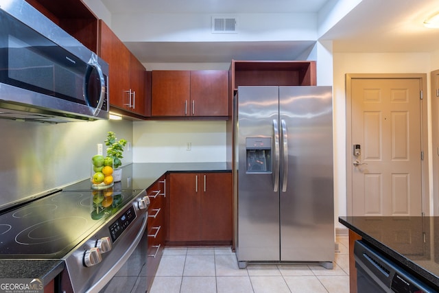 390 17th St NW Unit 2040, Atlanta, GA 30363 - kitchen with appliances with stainless steel finishes, light tile patterned floors, and dark stone countertops