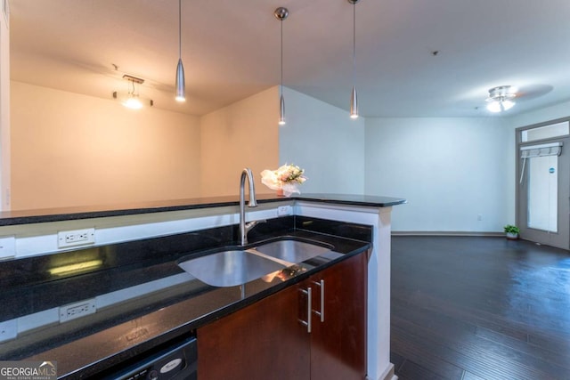 390 17th St NW Unit 2040, Atlanta, GA 30363 - kitchen with dark stone countertops, open floor plan, dark wood-type flooring, dishwashing machine, and pendant lighting