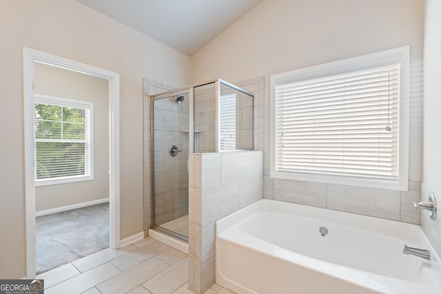 1537 Maplecliff Way, Sugar Hill, GA 30518 - full bathroom featuring a bath, a stall shower, vaulted ceiling, tile patterned floors, and baseboards