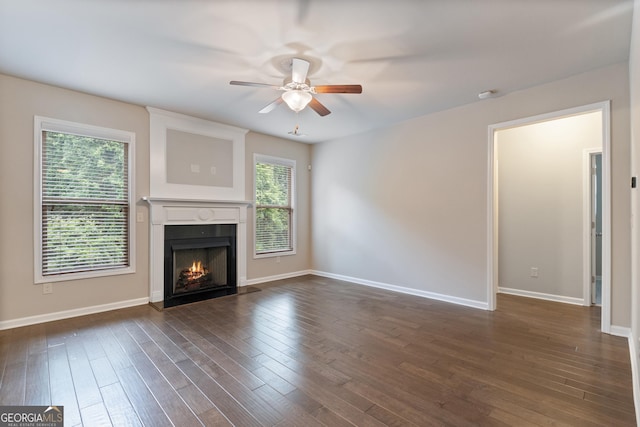 1537 Maplecliff Way, Sugar Hill, GA 30518 - unfurnished living room featuring a ceiling fan, a warm lit fireplace, and dark wood-style floors