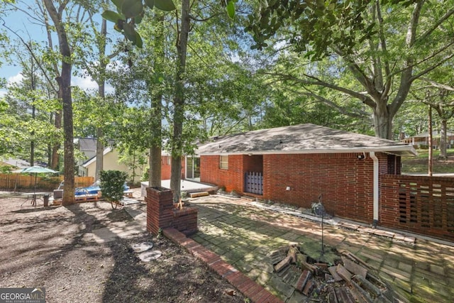 5222 Skyline Dr, Stone Mountain, GA 30083 - view of front of home featuring brick siding, a patio, and a shingled roof