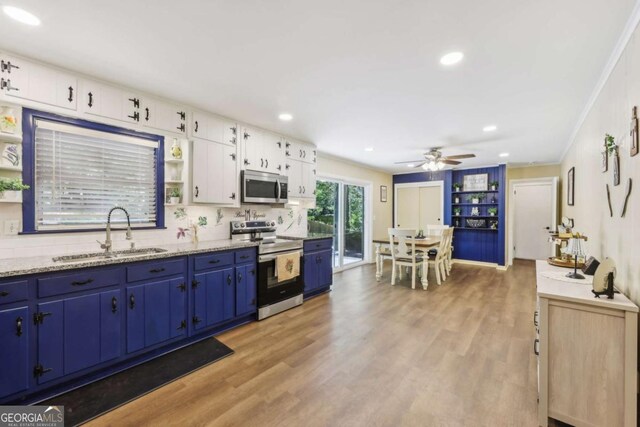 5222 Skyline Dr, Stone Mountain, GA 30083 - kitchen with appliances with stainless steel finishes, a sink, blue cabinetry, light wood-type flooring, and recessed lighting