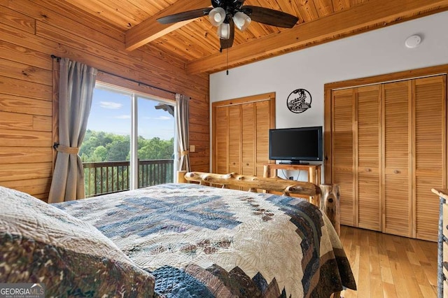 325 Emelia Dr, Morganton, GA 30560 - bedroom with wooden ceiling with exposed beams, access to outside, two closets, light wood finished floors, and wood walls