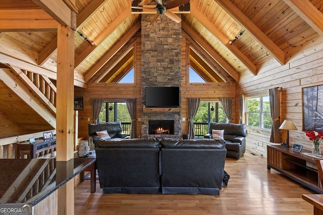 325 Emelia Dr, Morganton, GA 30560 - living area with wood ceiling with exposed beams, plenty of natural light, a ceiling fan, a fireplace, and hardwood / wood-style floors