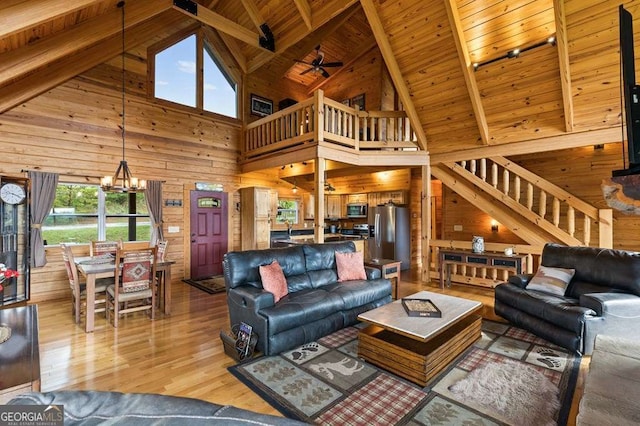 325 Emelia Dr, Morganton, GA 30560 - living area with wooden walls, wooden ceiling with exposed beams, high vaulted ceiling, a chandelier, and light wood finished floors