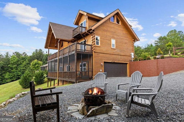 325 Emelia Dr, Morganton, GA 30560 - back of house with an outdoor fire pit, a balcony, a garage, and log siding