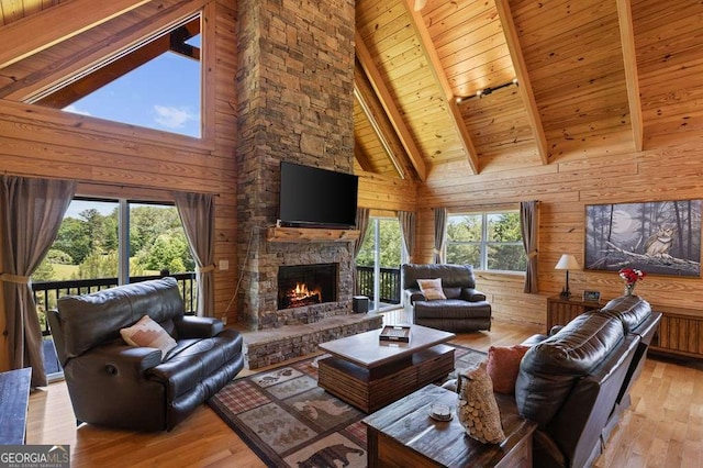 325 Emelia Dr, Morganton, GA 30560 - living area with high vaulted ceiling, wooden walls, healthy amount of natural light, wooden ceiling with exposed beams, and a stone fireplace