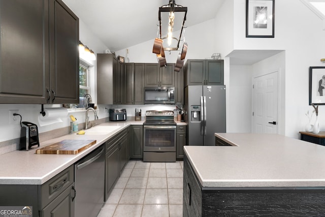 425 Wagers Mill Rd, Newnan, GA 30263 - kitchen with appliances with stainless steel finishes, a sink, high vaulted ceiling, light tile patterned flooring, and light countertops