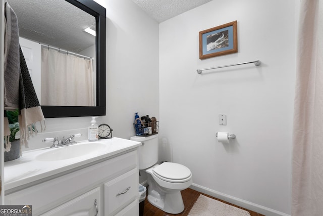425 Wagers Mill Rd, Newnan, GA 30263 - full bath featuring a textured ceiling, toilet, wood finished floors, vanity, and baseboards