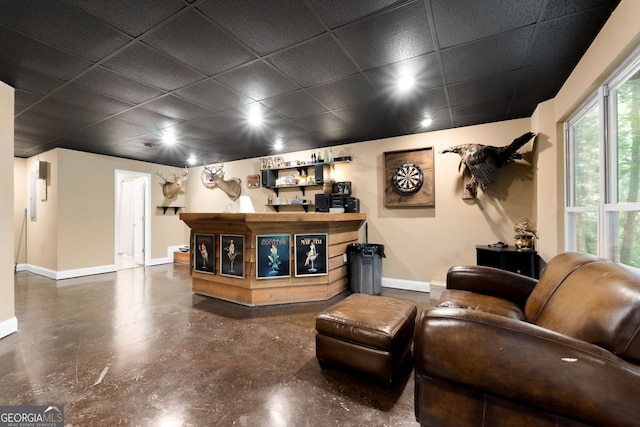 425 Wagers Mill Rd, Newnan, GA 30263 - living area with a drop ceiling, baseboards, finished concrete flooring, and bar