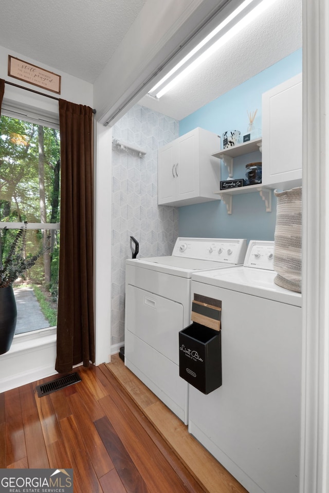 425 Wagers Mill Rd, Newnan, GA 30263 - laundry area featuring cabinet space, independent washer and dryer, and light wood-style floors