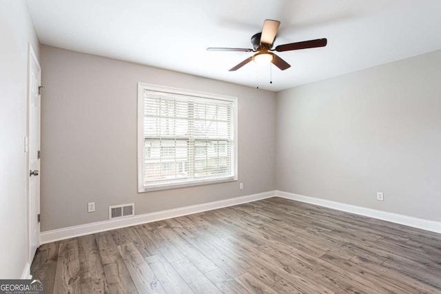 7 Villa Ct SE, Smyrna, GA 30080 - unfurnished room featuring wood finished floors, a ceiling fan, and baseboards