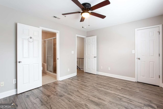7 Villa Ct SE, Smyrna, GA 30080 - unfurnished bedroom with baseboards, wood finished floors, connected bathroom, and a ceiling fan
