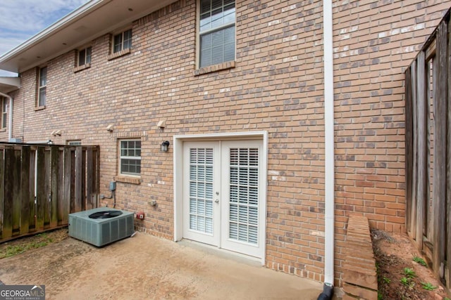 7 Villa Ct SE, Smyrna, GA 30080 - rear view of house featuring central air condition unit, brick siding, a patio area, and french doors