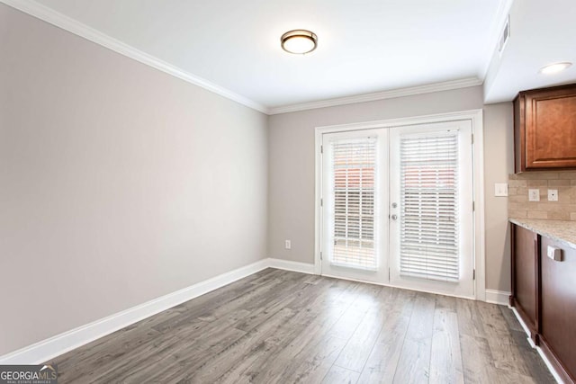 7 Villa Ct SE, Smyrna, GA 30080 - unfurnished dining area featuring french doors, wood finished floors, ornamental molding, and baseboards