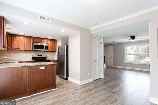 7 Villa Ct SE, Smyrna, GA 30080 - kitchen featuring appliances with stainless steel finishes, light stone countertops, brown cabinets, tasteful backsplash, and ornamental molding
