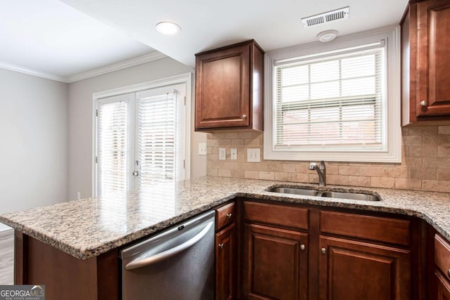 7 Villa Ct SE, Smyrna, GA 30080 - kitchen with dishwasher, a sink, a peninsula, decorative backsplash, and light stone countertops