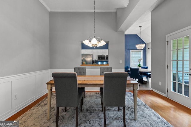 264 Baldwin Ct, Newnan, GA 30263 - dining room featuring a chandelier, wood finished floors, crown molding, and a towering ceiling