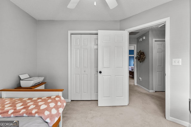 264 Baldwin Ct, Newnan, GA 30263 - bedroom with light colored carpet, a closet, a ceiling fan, and a textured ceiling