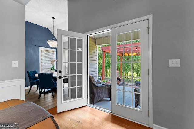 264 Baldwin Ct, Newnan, GA 30263 - entryway featuring wood finished floors, a chandelier, lofted ceiling, and french doors