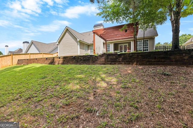 264 Baldwin Ct, Newnan, GA 30263 - back of house with french doors, a fenced backyard, and a chimney