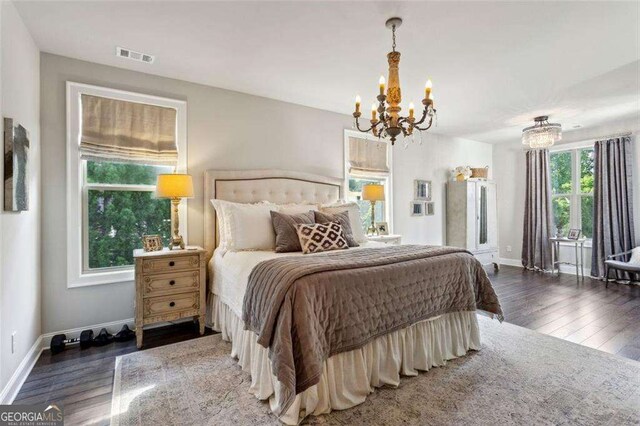 4355 Parkside Pl, Sandy Springs, GA 30342 - bedroom featuring a chandelier, wood finished floors, and baseboards