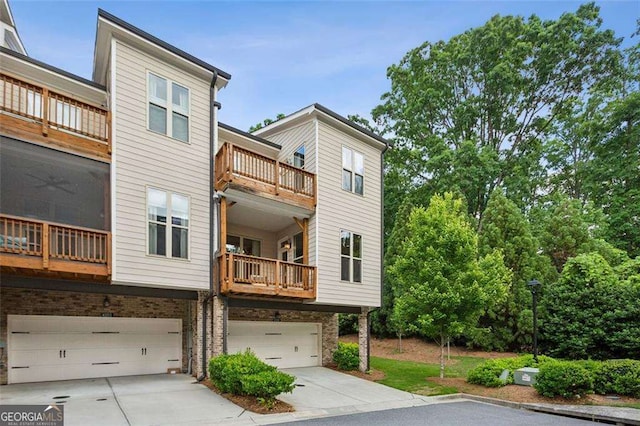 4355 Parkside Pl, Sandy Springs, GA 30342 - rear view of house featuring a garage, driveway, a balcony, and brick siding