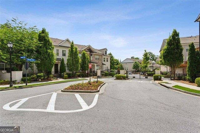 4355 Parkside Pl, Sandy Springs, GA 30342 - view of asphalt street featuring a residential view, sidewalks, curbs, and traffic signs