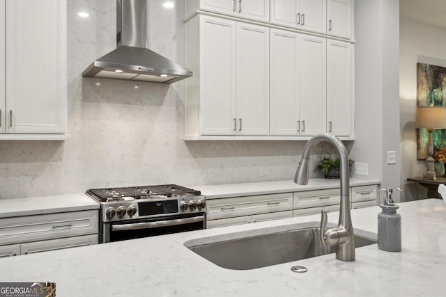 4355 Parkside Pl, Sandy Springs, GA 30342 - kitchen with wall chimney range hood, gas stove, a sink, and light stone counters