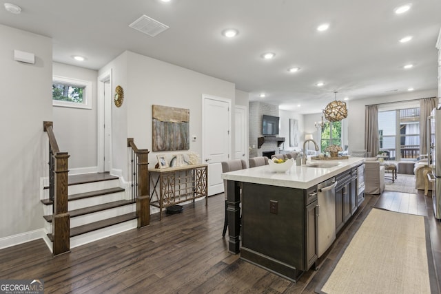 4355 Parkside Pl, Sandy Springs, GA 30342 - kitchen with open floor plan, a sink, dark wood-type flooring, a center island with sink, and dishwasher