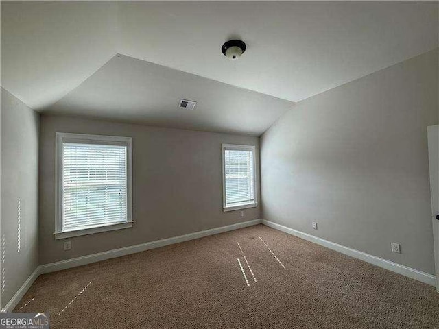 3488 Woodshade Dr, Loganville, GA 30052 - bonus room featuring vaulted ceiling, carpet flooring, and baseboards