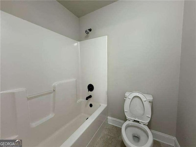 3488 Woodshade Dr, Loganville, GA 30052 - full bath featuring baseboards, toilet, shower / washtub combination, and tile patterned flooring