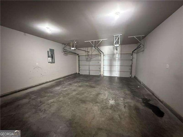 3488 Woodshade Dr, Loganville, GA 30052 - garage featuring electric panel, a garage door opener, and baseboards