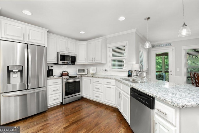 310 Medridge Dr, Alpharetta, GA 30022 - kitchen featuring appliances with stainless steel finishes, a sink, a peninsula, crown molding, and white cabinetry