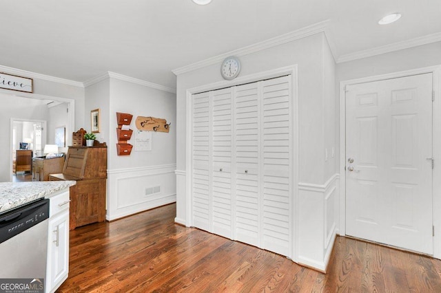 310 Medridge Dr, Alpharetta, GA 30022 - kitchen with stainless steel dishwasher, dark wood-style flooring, light stone countertops, ornamental molding, and white cabinets