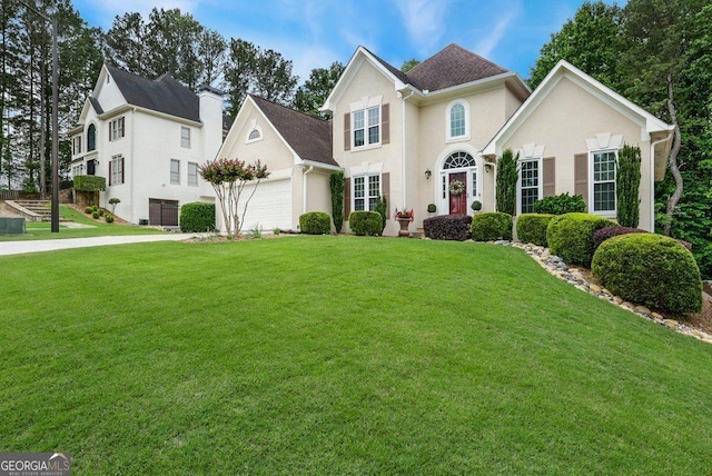 310 Medridge Dr, Alpharetta, GA 30022 - view of front of property with an attached garage, a front yard, and stucco siding