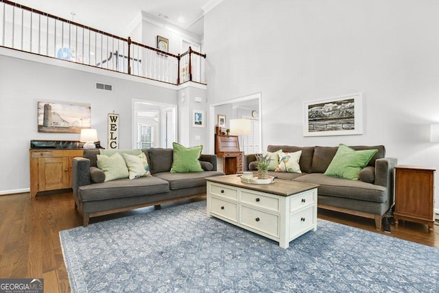 310 Medridge Dr, Alpharetta, GA 30022 - living room featuring ornamental molding, dark wood-style floors, a high ceiling, and baseboards