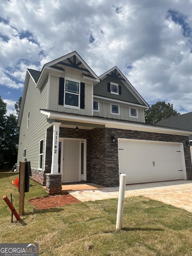 11142 Cornerstone Way, Hampton, GA 30228 - craftsman house featuring board and batten siding, stone siding, a front lawn, and driveway
