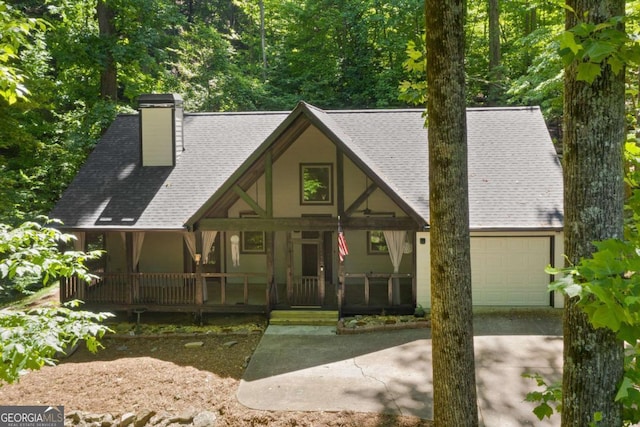 532 Coffee Cove Dr, Jasper, GA 30143 - view of front of home with a porch, concrete driveway, a garage, a chimney, and roof with shingles