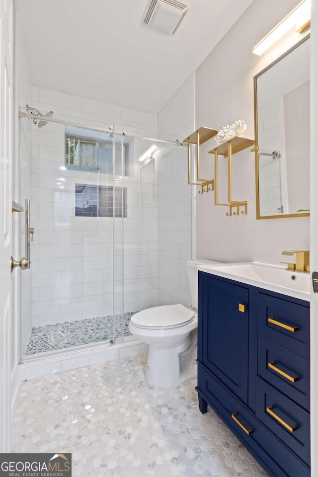 532 Coffee Cove Dr, Jasper, GA 30143 - bathroom featuring toilet, vanity, a stall shower, and tile patterned floors