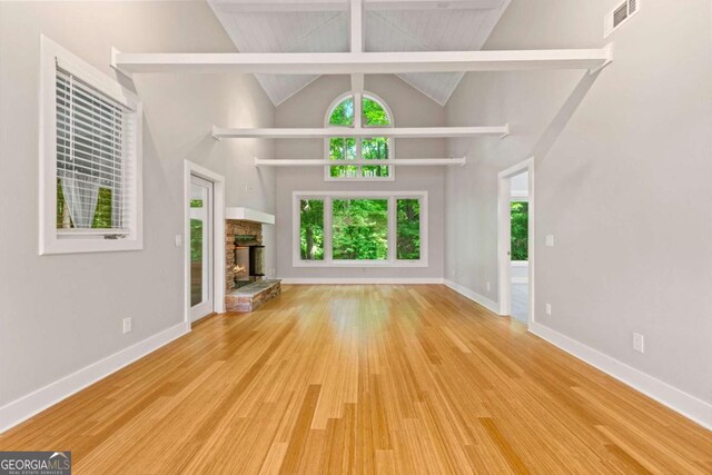 532 Coffee Cove Dr, Jasper, GA 30143 - unfurnished living room with wood finished floors, a fireplace, high vaulted ceiling, and baseboards