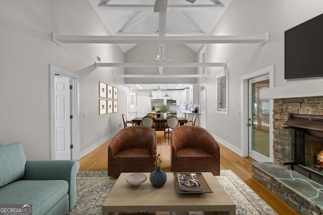 532 Coffee Cove Dr, Jasper, GA 30143 - living room featuring ceiling fan, a fireplace, light wood-style floors, beam ceiling, and high vaulted ceiling